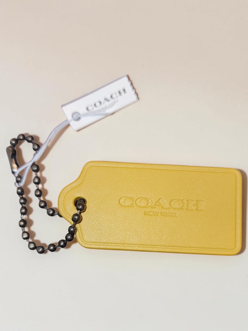 Coach Leather Hang Tag with Foil Print of an Apple on the Back